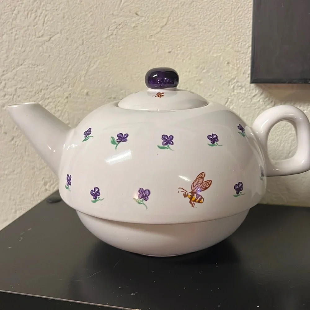 Small white teapot with violet and bee details.